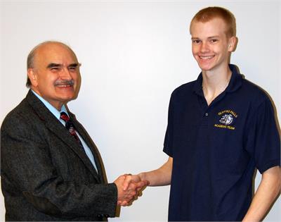 Program Producer Jim Mehrling congratulates Andy Nageotte for winning the “Standout Scholar” award on the Apr. 14th broadcast of the High School Scholastic Games quiz program on WEOL (AM 930).